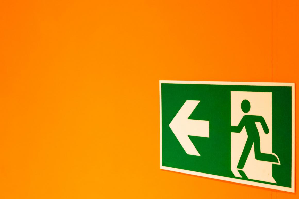Fire exit sign with orange background colour.