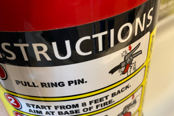 Fire extinguisher with instructions sticker.