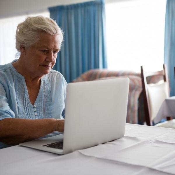 Senior woman using laptop.