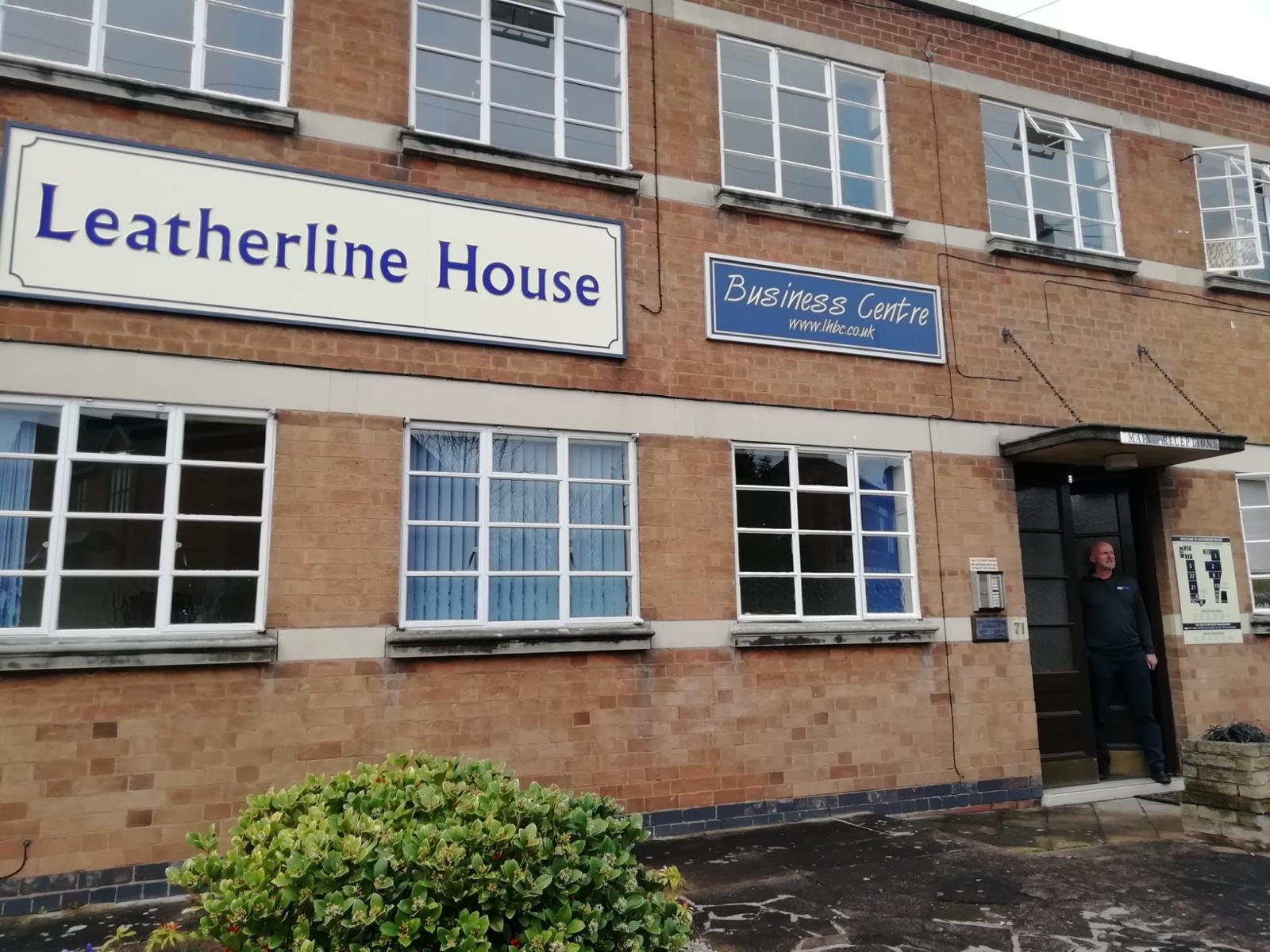 ISE Fire employee stood outside Leicester Leatherline House business office