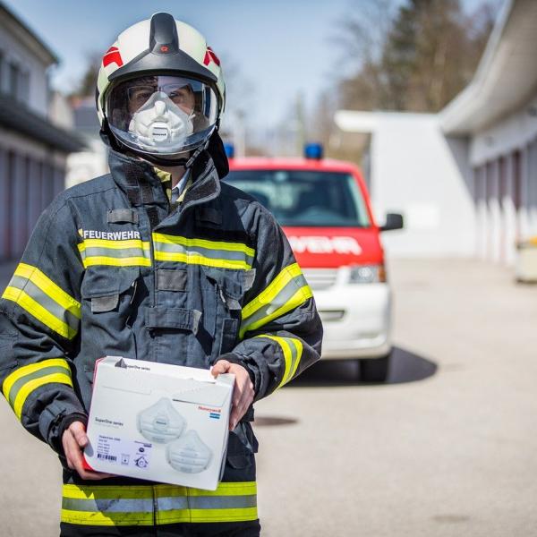 Firefighter man holding a box of face mask.